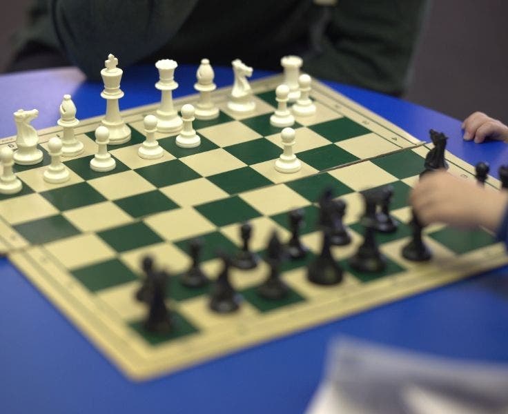 A chess set, with chess pieces on it.