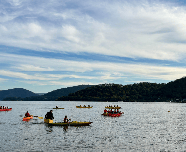 Canoes with children in the water.